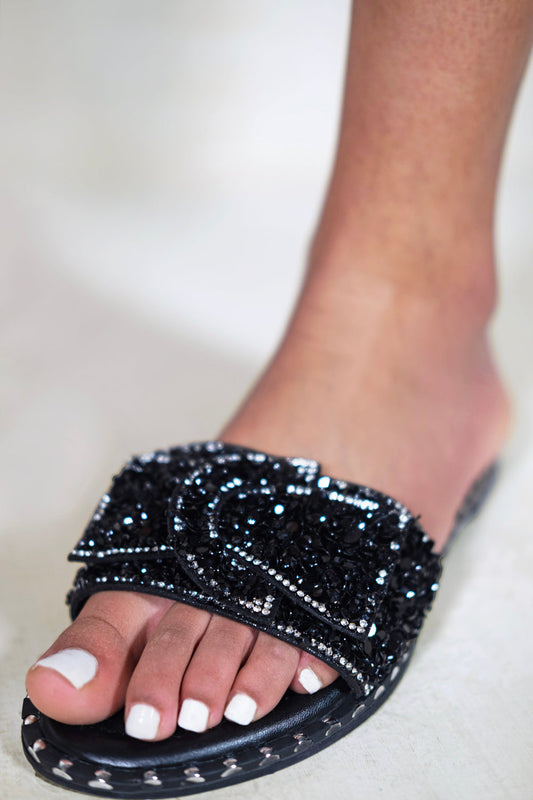 KAMARI DIAMANTE BOW FLAT SLIDERS WITH STUD DETAILS IN BLACK
