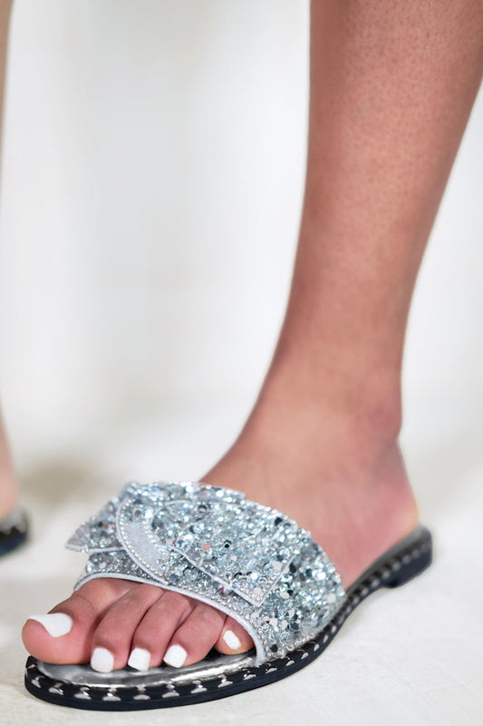 KAMARI DIAMANTE BOW FLAT SLIDERS WITH STUD DETAILS IN MOON SILVER
