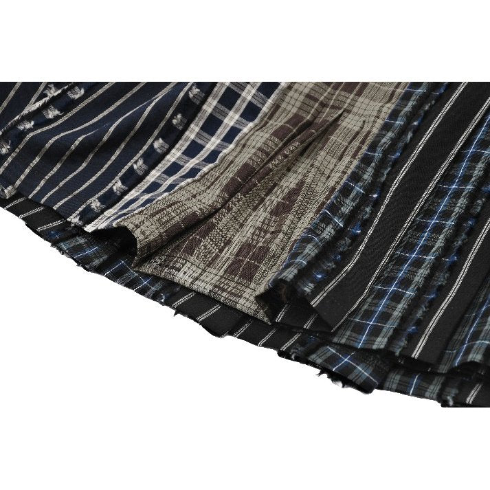 Mini-jupe plissée Dark in Love en patchwork tartan sauge et taille en cuir
