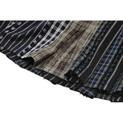 Mini-jupe plissée Dark in Love en patchwork tartan sauge et taille en cuir