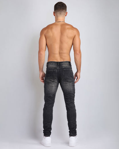 Black Ripped Jeans with Striking Black Patches