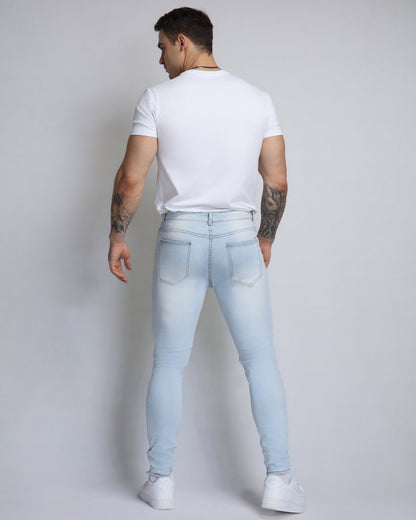 Jean bleu déchiré délavé avec patch fleur de cajou rose