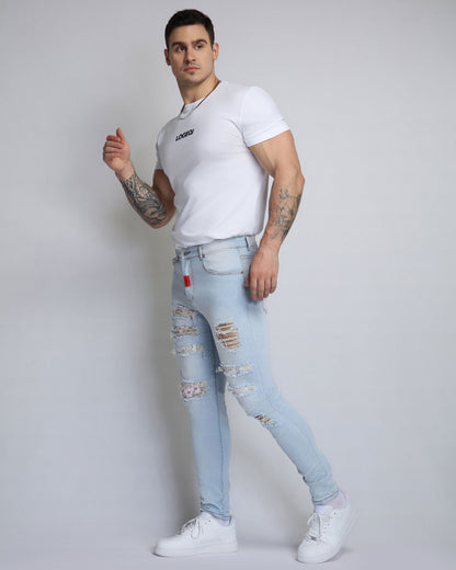 Jean bleu déchiré délavé avec patch fleur de cajou rose