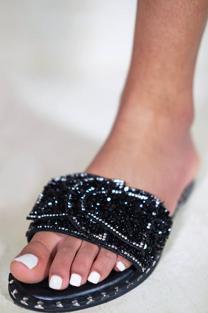 KAMARI DIAMANTE BOW FLAT SLIDERS WITH STUD DETAILS IN BLACK
