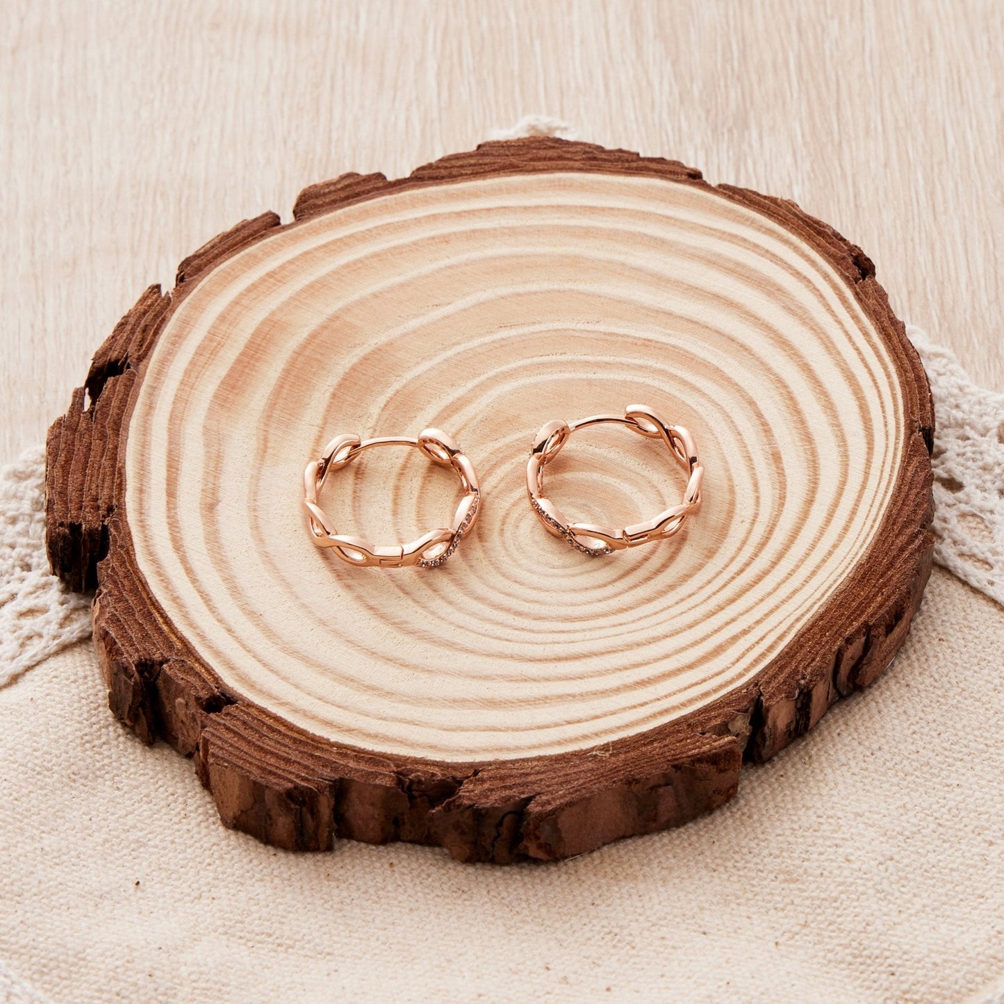 Rose Gold Plated Infinity Hoop Earrings Created with Zircondia® Crystals